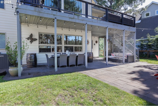 rear view of house with a yard, a patio, stairway, and an outdoor hangout area