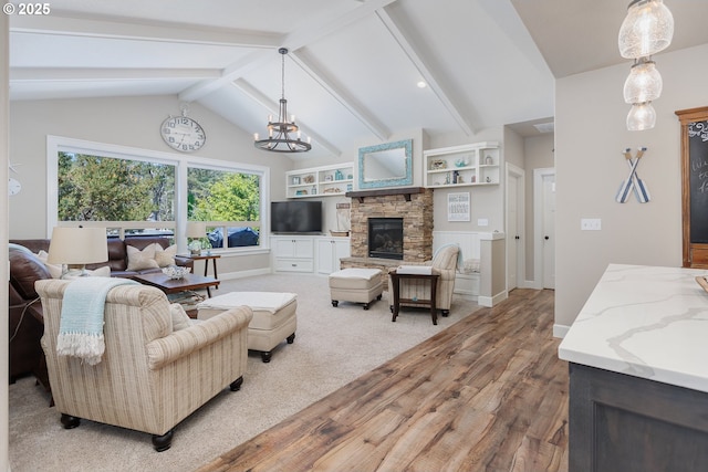 living room featuring baseboards, vaulted ceiling with beams, light wood-style floors, a fireplace, and a chandelier