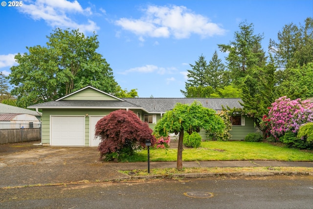 view of front of home with driveway, an attached garage, and roof with shingles