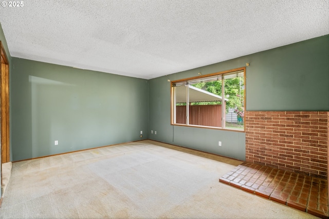 carpeted spare room featuring a textured ceiling