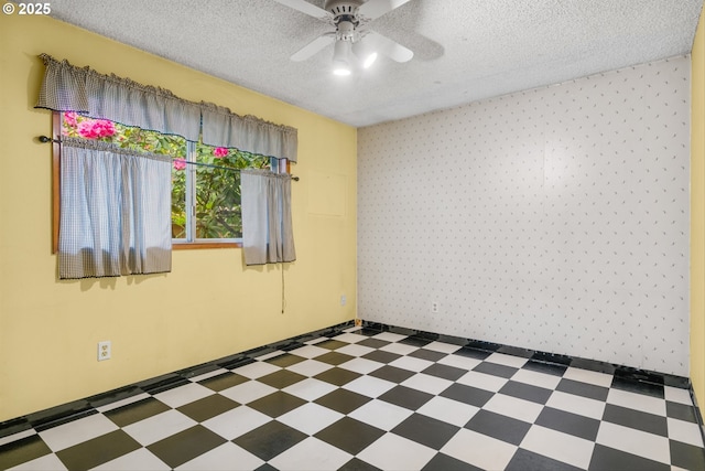 unfurnished room featuring tile patterned floors, ceiling fan, and a textured ceiling