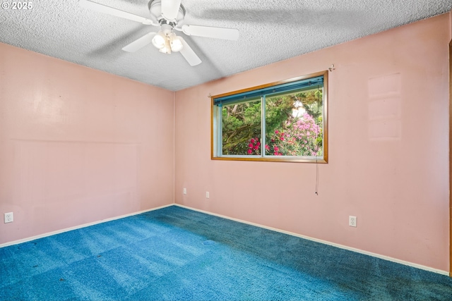 spare room featuring a textured ceiling, carpet flooring, ceiling fan, and baseboards