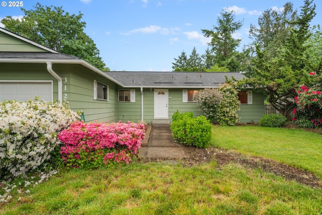 single story home with a front lawn and a garage