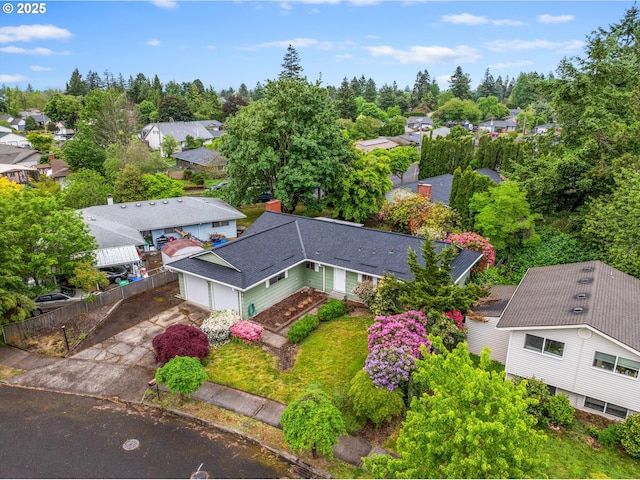 aerial view of residential area featuring a tree filled landscape