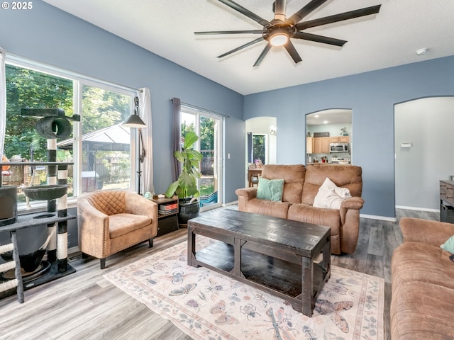 35530 Edies Way, Saint Helens, OR 97051 - living area with arched walkways, a ceiling fan, and wood finished floors