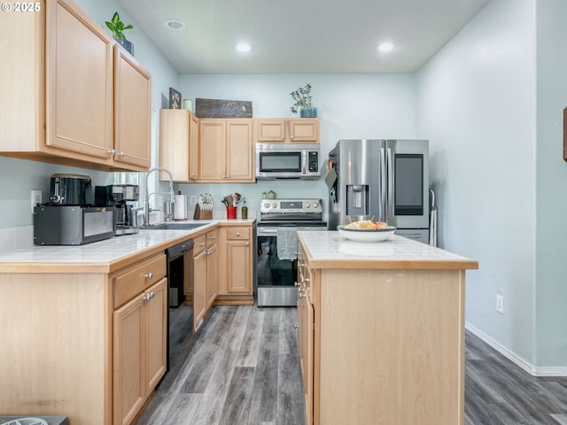 35530 Edies Way, Saint Helens, OR 97051 - kitchen featuring appliances with stainless steel finishes, light brown cabinetry, tile countertops, light wood-style flooring, and recessed lighting
