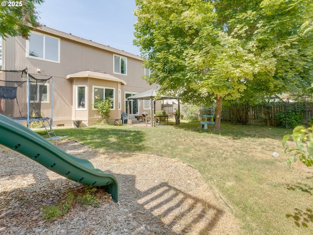 35530 Edies Way, Saint Helens, OR 97051 - fenced backyard featuring a trampoline, a gazebo, and a playground