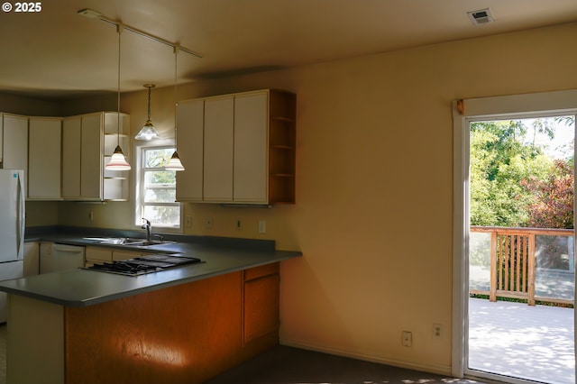 74 NE Sacramento St, Portland, OR 97213 - kitchen with a sink, white appliances, a peninsula, open shelves, and healthy amount of natural light