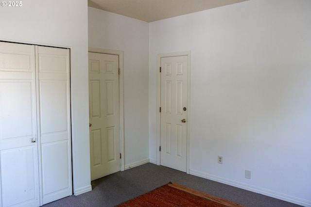 74 NE Sacramento St, Portland, OR 97213 - unfurnished bedroom featuring dark carpet, baseboards, and a closet