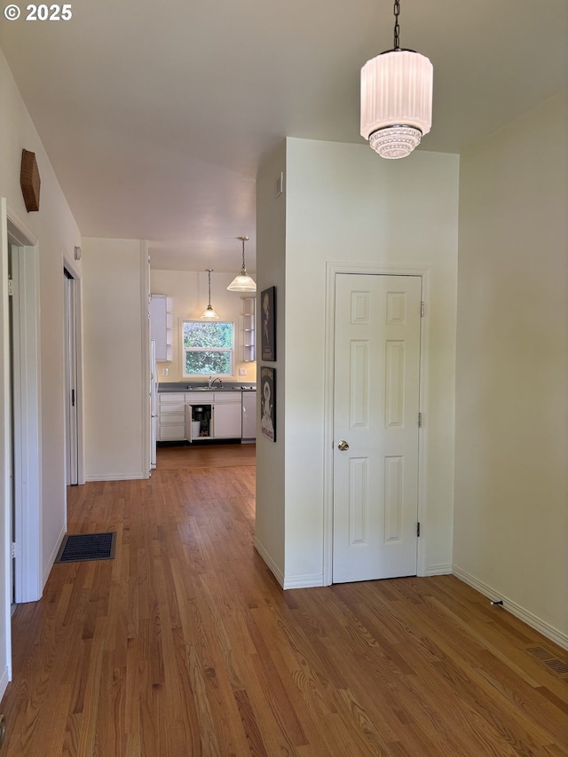 74 NE Sacramento St, Portland, OR 97213 - corridor with wood finished floors, baseboards, and a sink