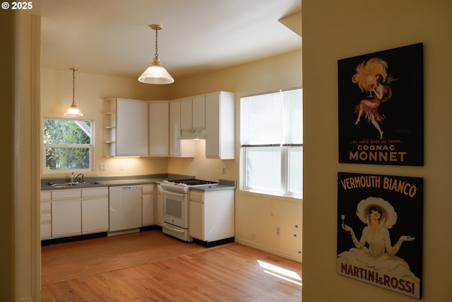 74 NE Sacramento St, Portland, OR 97213 - kitchen with white appliances, a sink, light wood-type flooring, white cabinetry, and decorative light fixtures