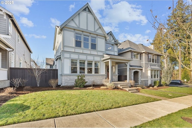 tudor home featuring a front yard