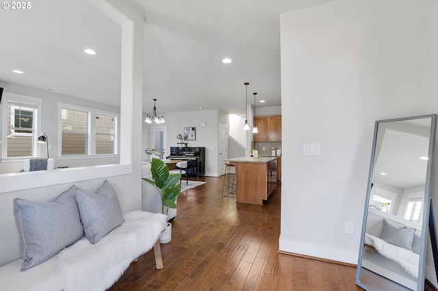 living room featuring dark hardwood / wood-style floors and a chandelier