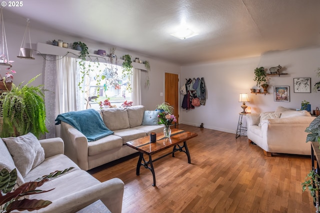 living area featuring light wood-type flooring and baseboards