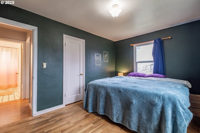 bedroom featuring baseboards and light wood-style floors