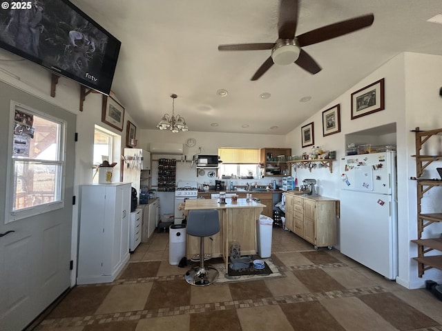 37102 Woods Ln, Richland, OR 97870 - kitchen featuring ceiling fan with notable chandelier, freestanding refrigerator, open shelves, and lofted ceiling
