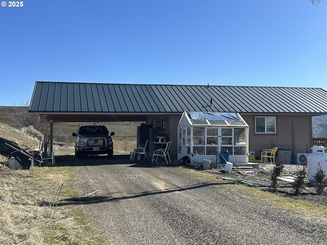 exterior space with driveway and a carport