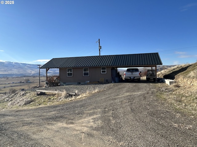 37102 Woods Ln, Richland, OR 97870 - rear view of property with a mountain view, dirt driveway, metal roof, and a carport