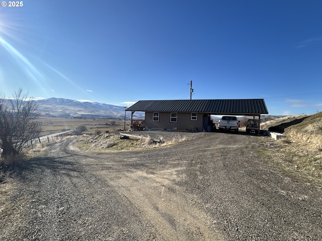37102 Woods Ln, Richland, OR 97870 - view of front of home featuring a mountain view, metal roof, and driveway