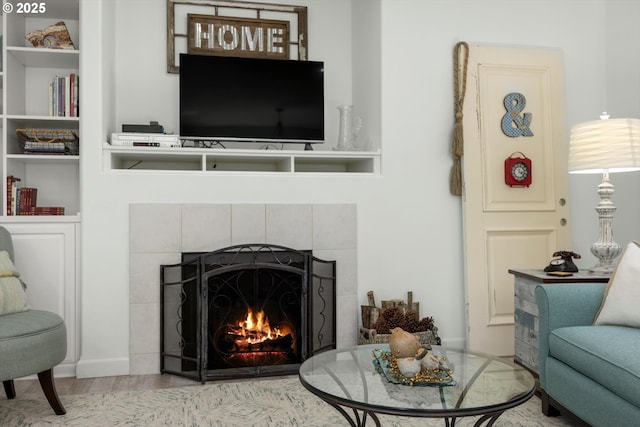 19774 SW Ashcroft Ln, Beaverton, OR 97003 - living room with a tiled fireplace, wood finished floors, and built in shelves