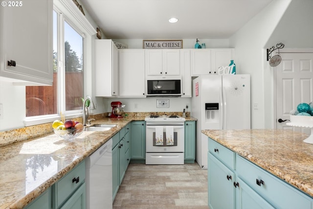 19774 SW Ashcroft Ln, Beaverton, OR 97003 - kitchen featuring white appliances, light wood-style flooring, a sink, light stone countertops, and recessed lighting
