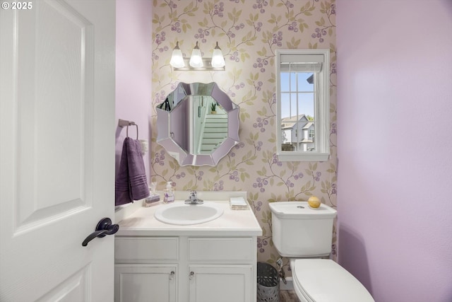19774 SW Ashcroft Ln, Beaverton, OR 97003 - half bathroom featuring wallpapered walls, vanity, and toilet