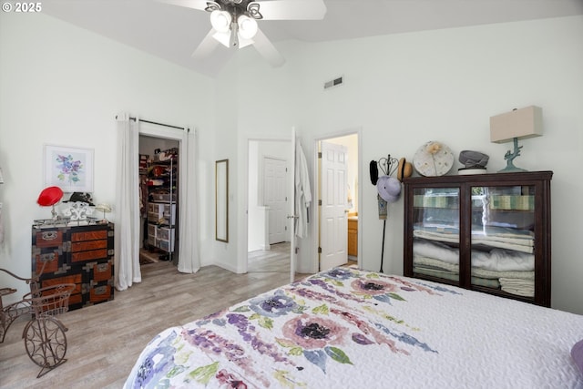 19774 SW Ashcroft Ln, Beaverton, OR 97003 - bedroom featuring light wood-style flooring, a ceiling fan, high vaulted ceiling, a walk in closet, and a closet