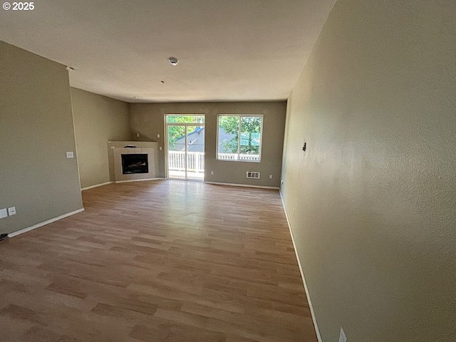 19903 SW Poplarwood Pl, Tualatin, OR 97062 - unfurnished living room featuring wood finished floors and a fireplace