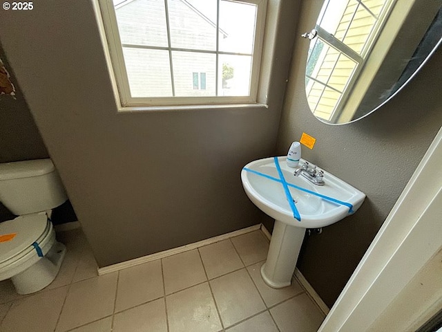 19903 SW Poplarwood Pl, Tualatin, OR 97062 - half bathroom featuring healthy amount of natural light and tile patterned floors