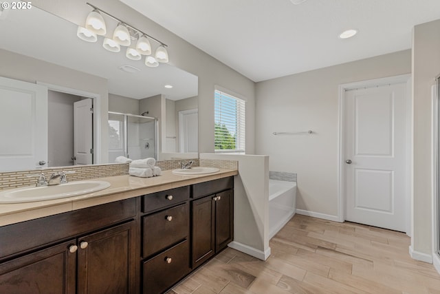 2908 S White Salmon Dr, Ridgefield, WA 98642 - bathroom featuring a shower stall, double vanity, a bath, and wood finished floors