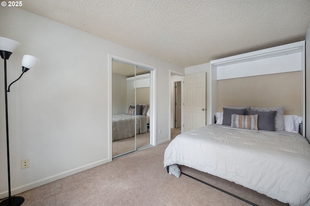 bedroom featuring a closet, a textured ceiling, and carpet flooring