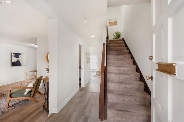 stairs featuring hardwood / wood-style flooring