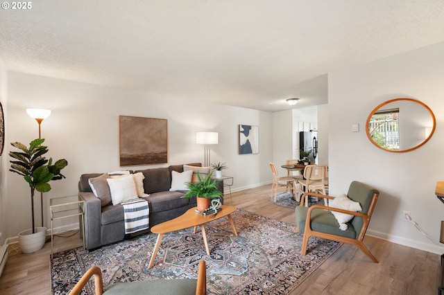 living room featuring a textured ceiling and hardwood / wood-style floors