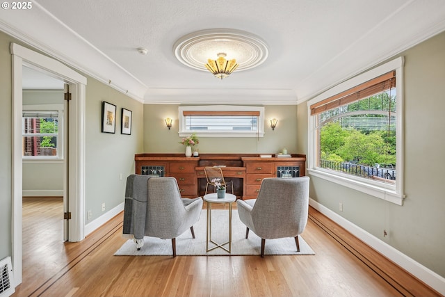 interior space featuring ornamental molding, plenty of natural light, and wood finished floors