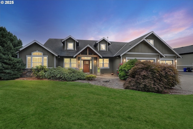 view of front facade featuring board and batten siding, a front lawn, and a shingled roof