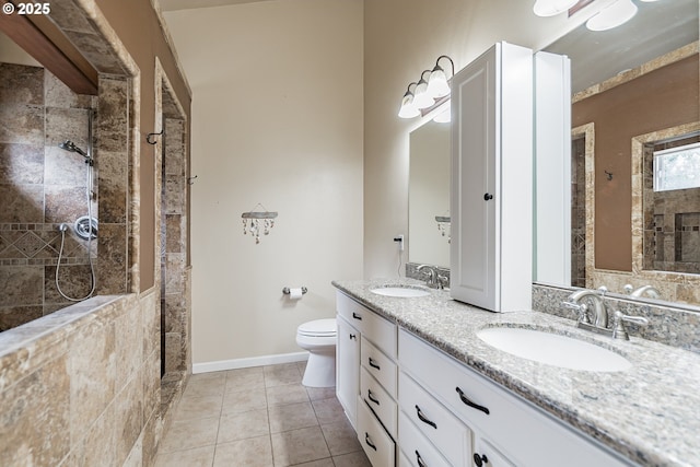 full bathroom with tiled shower, tile patterned floors, toilet, and double vanity