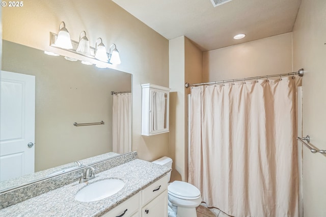 bathroom featuring toilet, vanity, tile patterned flooring, and a shower with curtain