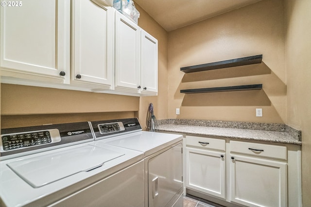 washroom with cabinet space and independent washer and dryer