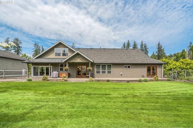rear view of property featuring french doors and a patio area