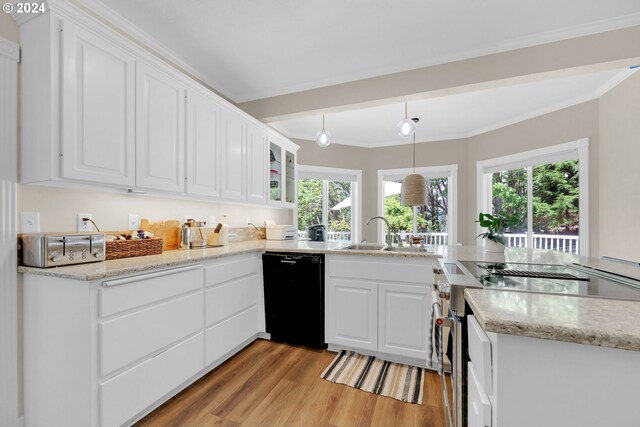 7297 Holly St, Springfield, OR 97478 - kitchen featuring black dishwasher, stainless steel range oven, light wood-type flooring, crown molding, and white cabinets