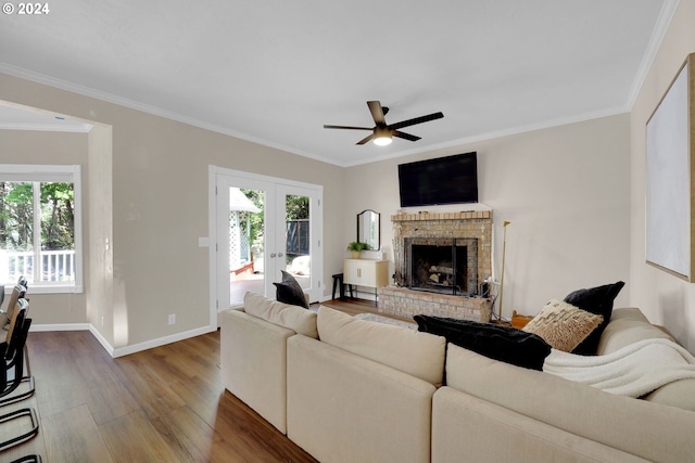 7297 Holly St, Springfield, OR 97478 - living room with wood finished floors, healthy amount of natural light, a ceiling fan, ornamental molding, and a fireplace