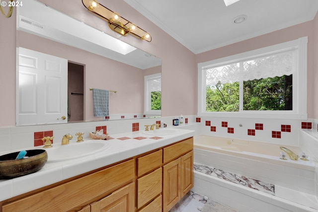 7297 Holly St, Springfield, OR 97478 - bathroom featuring double vanity, a garden tub, ornamental molding, and a skylight