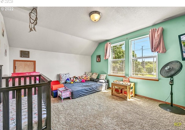 10387 N Mohawk Ave, Portland, OR 97203 - bedroom with carpet, vaulted ceiling, a textured ceiling, and baseboards