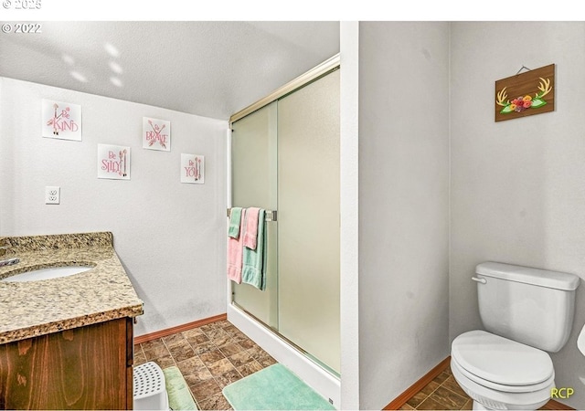 10387 N Mohawk Ave, Portland, OR 97203 - full bathroom with baseboards, a shower stall, vanity, and toilet