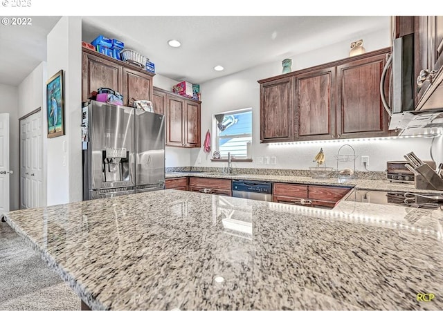 10387 N Mohawk Ave, Portland, OR 97203 - kitchen with appliances with stainless steel finishes, light stone counters, recessed lighting, a sink, and a peninsula