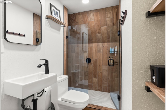 226 N Highland St, Portland, OR 97217 - bathroom with toilet, a stall shower, a sink, and a textured wall
