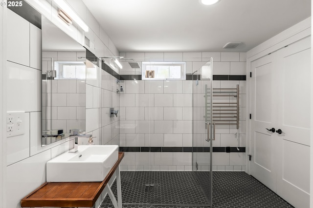226 N Highland St, Portland, OR 97217 - full bathroom featuring a stall shower, radiator heating unit, vanity, tile patterned flooring, and tile walls