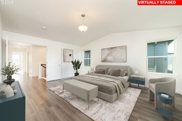 bedroom featuring hardwood / wood-style flooring and vaulted ceiling