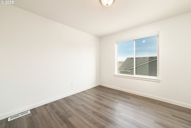 unfurnished room with hardwood / wood-style flooring