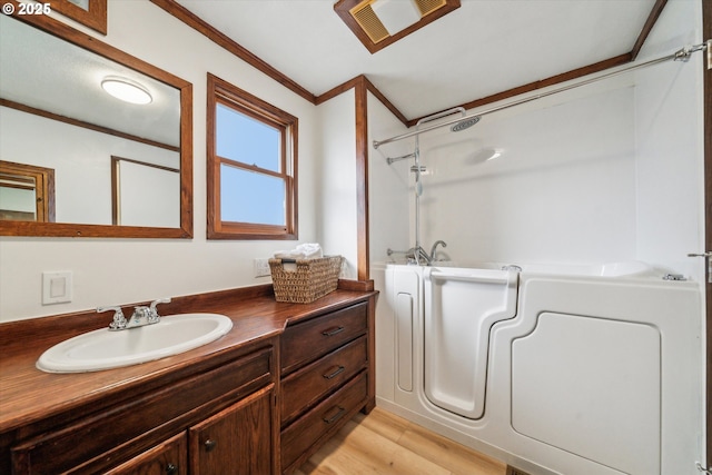 bathroom with vanity, visible vents, ornamental molding, walk in shower, and a bathtub